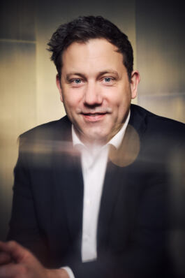 Portrait of a confident man in formal attire for Leopold Fiala Photography. 