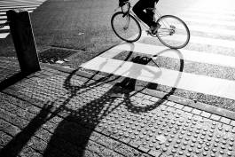 Cycling shadow on road 