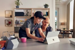 Bald man and female collaborating on laptop 