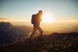 Hiker facing sunrise 