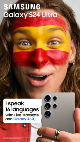 A person with face paint holds a Samsung Galaxy S24 Ultra, advertising its ability to speak 16 languages using Live Translate and Galaxy AI. 