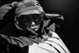 Hedvig Wessel Free ski World Chamption wearing protective gear, including a rain jacket and goggles, is depicted in a dramatic black-and-white close-up image. 