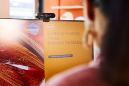 A person views a computer screen displaying 