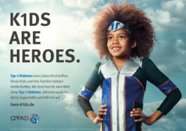 Child in superhero costume stands confidently beneath 